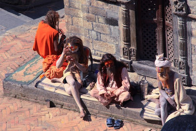 People sitting at historical building