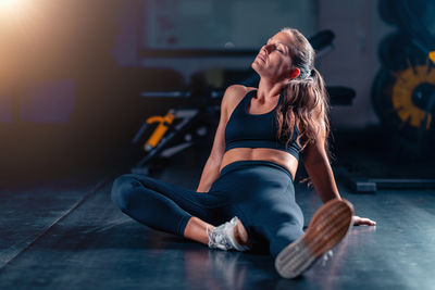 Young woman exercising in gym
