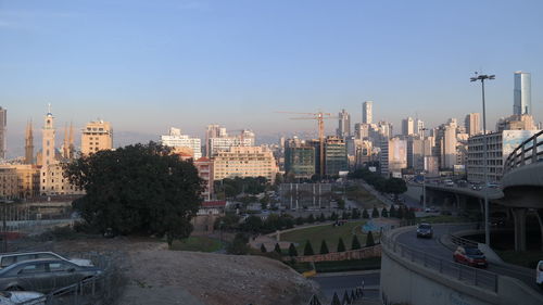 Buildings in city against clear sky