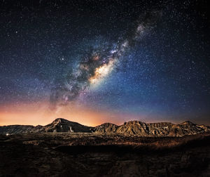 Scenic view of mountains against sky at night