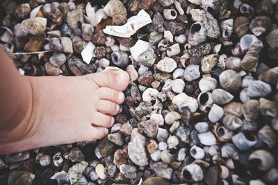 Childs foot on beach, close-up