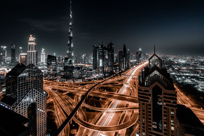 Aerial view of illuminated buildings in city at night