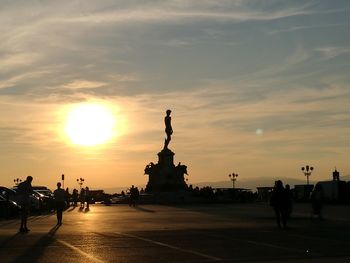 Silhouette of statues at sunset