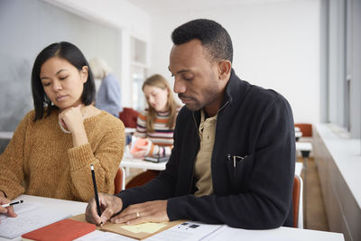 Adult students making notes in class