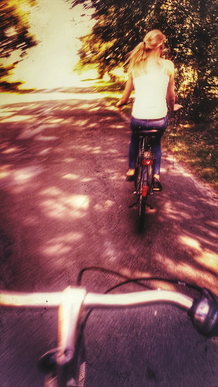 bicycle, cycling, transportation, full length, one person, outdoors, one young woman only, riding, road, real people, young adult, adults only, pedal, one woman only, day, people, adult