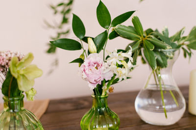 Pink eustoma and white hyacinth flowers in a glass vase in the decor of the house or table