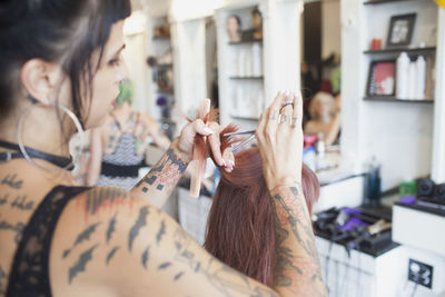 A hair dresser styling a customer's hair.