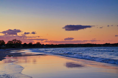 Scenic view of beach against sky during sunset