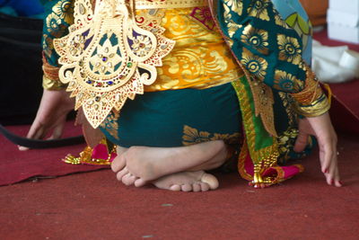 Low section of women sitting outdoors