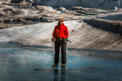 Woman standing on glacier