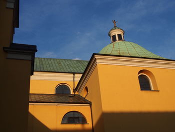 Low angle view of yellow building against sky