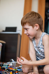 Young child boy plays constructor at home on the floor. preschool education. home fun. close-up,