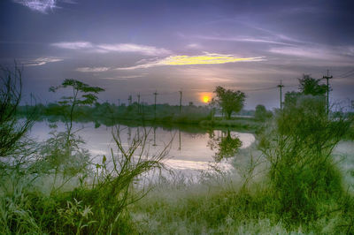 Scenic view of lake against sky during sunset