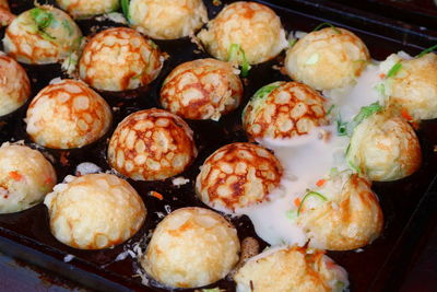 High angle view of fresh takoyakis in tray