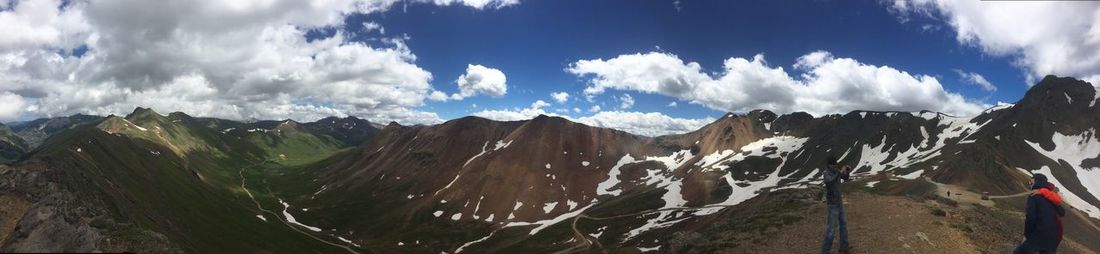 Scenic view of mountains against cloudy sky