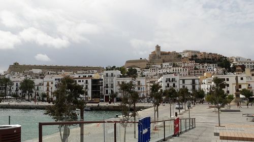 Town by sea against sky in city