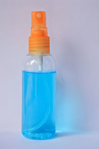 Close-up of blue bottle against white background