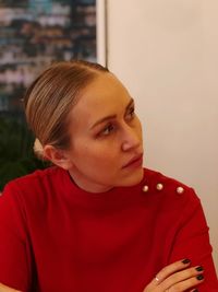 Close-up of young woman looking away at home