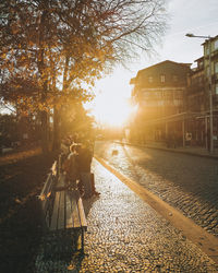 People walking on railroad track in city