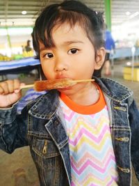 Portrait of cute baby girl holding flavored ice