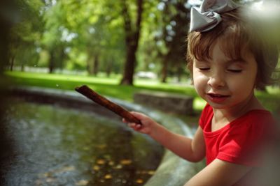 Girl playing in pond at park