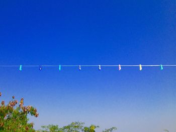 Low angle view of vapor trail against clear blue sky