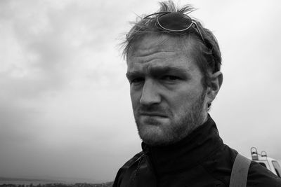 Portrait of mature man standing against sky