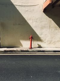 Fire hydrant against wall in city