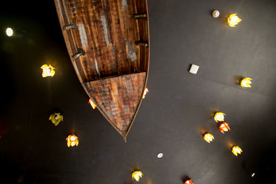 Low angle view of illuminated lighting equipment hanging on ceiling