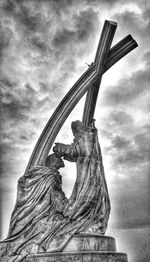 Low angle view of monument against cloudy sky