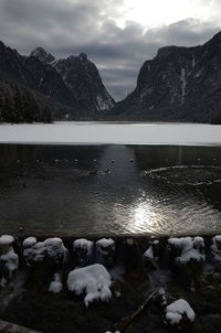 Scenic view of lake by mountains against sky