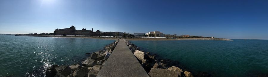 Panoramic view of sea against clear blue sky