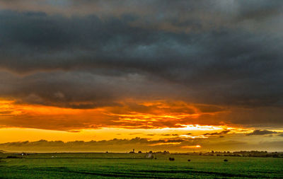 Scenic view of sunset over land