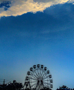 Ferris wheel against blue sky