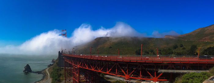 Panoramic view of bridge against blue sky