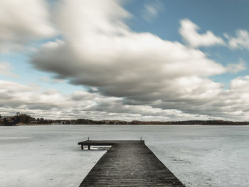 Pier over sea against sky