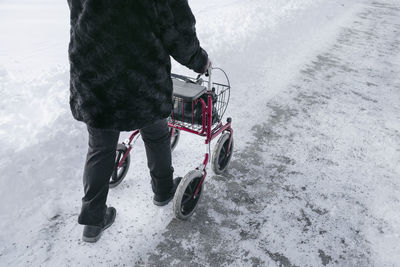 Senior with walking frame having walk at winter