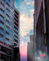 Low angle view of buildings against sky during sunset