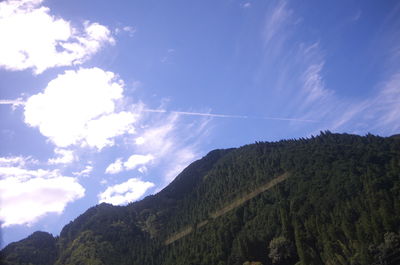 Low angle view of vapor trail against blue sky
