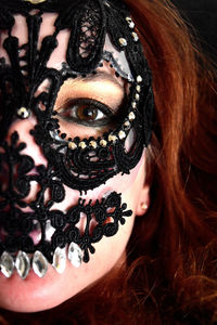 Cropped portrait of woman wearing lace mask