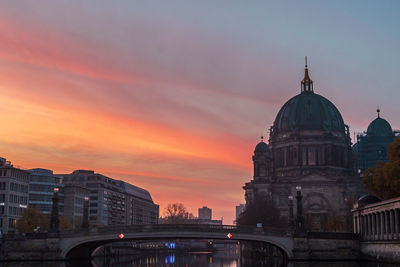 Buildings against sky during sunset in city