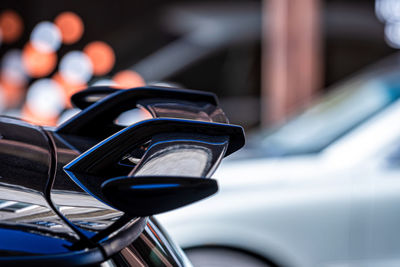 A row of cars parked on the side of the street, close-up of body elements