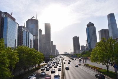 Vehicles on road against buildings in city