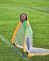 Portrait of smiling girl on grassy field