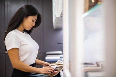 Side view of woman working at office