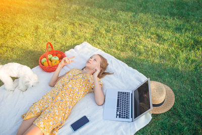 High angle view of woman lying down on grass