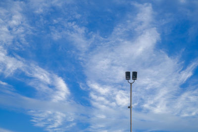 Low angle view of street light against blue sky