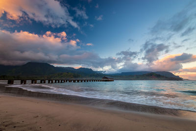 Scenic view of beach against sky during sunset