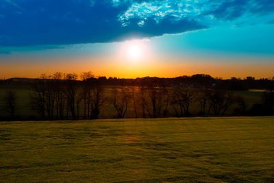 Scenic view of field against sky during sunset