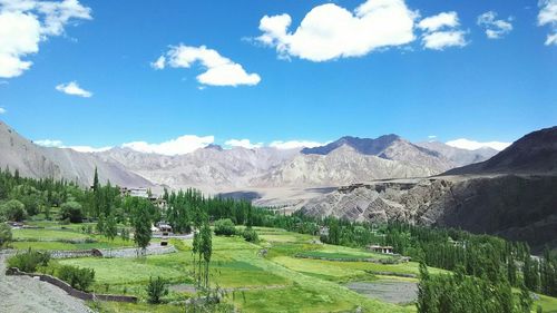Scenic view of mountains against cloudy sky